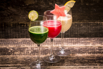 Fresh red and green smoothie on vintage wooden background.Healthy detox drink