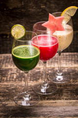 Fresh red and green smoothie on vintage wooden background.Healthy detox drink