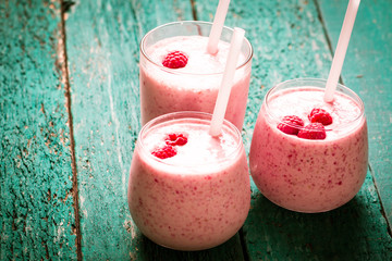 fresh raspberry smoothie on a wooden background.