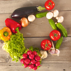 Composition with assorted raw organic vegetables wooden table