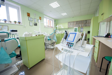 Stomatology equipment and instruments in dentist's office on the background of dental chairs and other equipment used by dentists