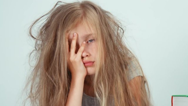 Portrait tired sad girl does not want to study