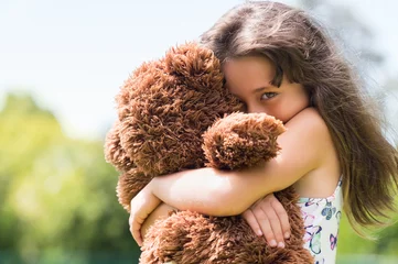 Fotobehang Girl embracing teddy bear © Rido