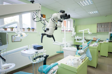 Close-up view of microscop in modern stomatological office on the background of dental chairs and...