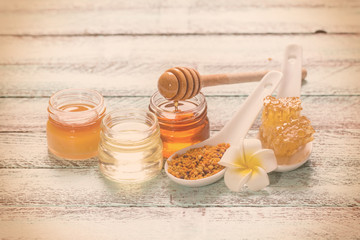 healthy honey composition, wooden background, vintage filters