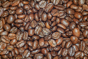 Coffee beans closeup. Roasted brown coffee beans texture or coffee beans background for design.