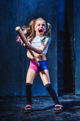 Little girl pointing in toy gun