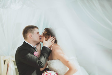 the groom kissing his beloved wife into the lips