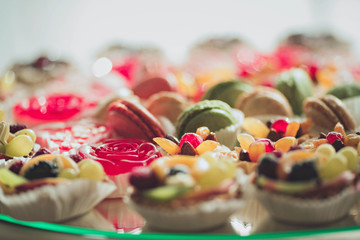 various candy and baskets of fruit are on the table