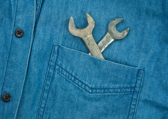 Wrench in blue jean pocket.