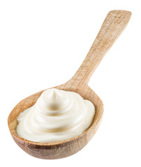 Mayonnaise swirl in the wooden spoon. File contains clipping pat