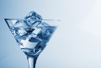 melting ice cubes and glass of alcohol studio shot