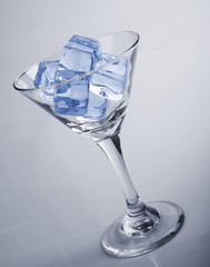 Studio shot of martini glass with ice cubes