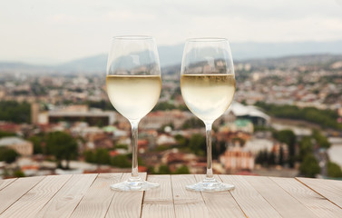 Two glasses on white wine on the table in Tbilisi, Georgia. - 120246228