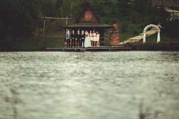 young couple and their friends walking by the lake
