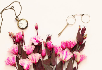 beautiful flowers and vintage glasses and pocket watch