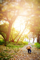 Fototapeta premium Cute little boy in funny clothes travelling in a forest