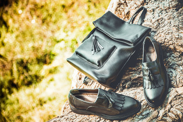 black leather shoes and a backpack, women's shoes