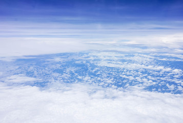 blue sky high view from airplane window clouds shapes