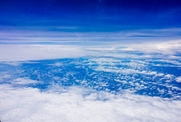 blue sky high view from airplane window clouds shapes