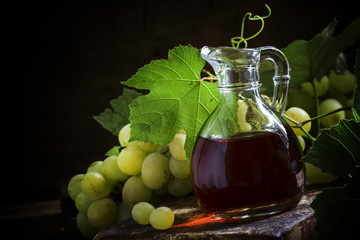 Wine vinegar in a jug. Still life in the rustic style. Selective