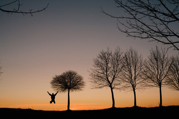 silhouette of a man who jumps at sunset