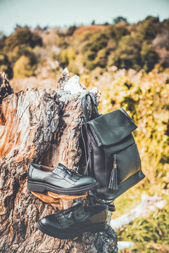 black leather shoes and a backpack, women's shoes