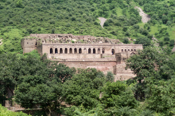 The historical ruins of the now famous Bhangarh Fort with ruins of temples, shops, gates and ramparts in the Rajgarh municipality of the Alwar district in the state of Rajasthan in India 
