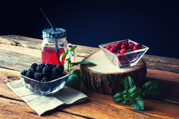 Fototapeta na wymiar Fresh drink with raspberries and blackberries