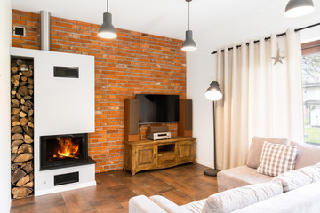 Modern room with brick wall and fireplace