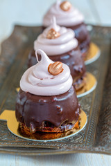 Cupcakes with chocolate frosting, meringue and hazelnut.