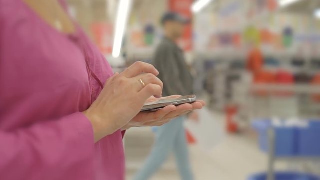 woman hands using mobile phone in Department store :