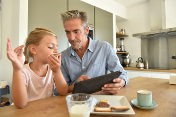 Daddy and little girl having a snack after school