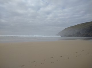 Cliff on misty beach