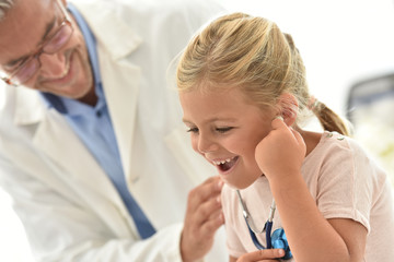 Little girl at the doctor's, using stethoscope