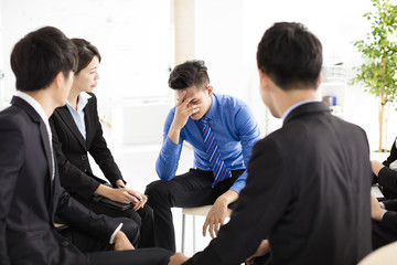 sad and depressed business man  during meeting