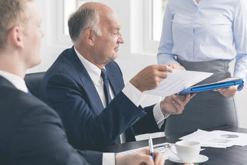 Successful mature businessman assisted by a devoted secretary
