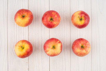 Red apples on the old wooden table.