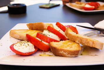 Italian caprese salad with  fresh mozzarella, tomatoes, olive oi