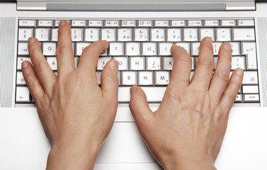 Close-up of female hands working on laptop