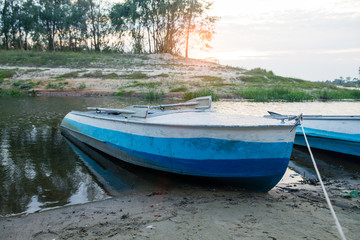 Naklejka na ściany i meble old metal boat on the river