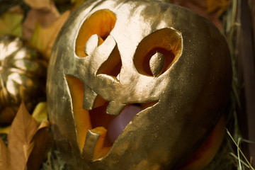 golden halloween pumpkin with scary face