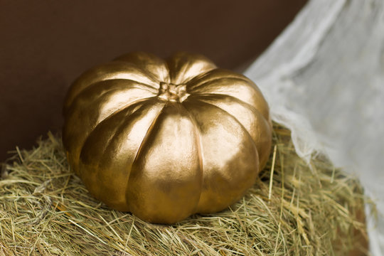 Golden Halloween Pumpkin On Straw Heap