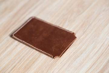 Leather crafting phone case handmade on wooden