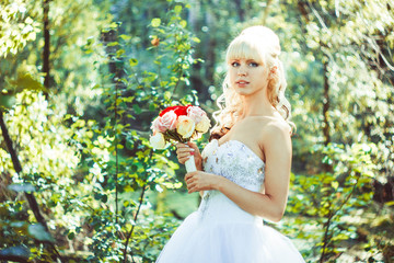 the girl in the woods with a bouquet of flowers