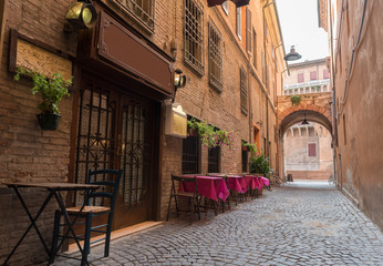 Fototapeta na wymiar Old pub in a tiny alley in the city center of Ferrara Italy