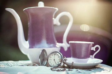 Purple teapot and cup on the table