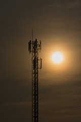 Silhouette electric pole back lit by the afternoon sun