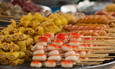 sausages and various food on skewers in a street kiosk. Meat pro