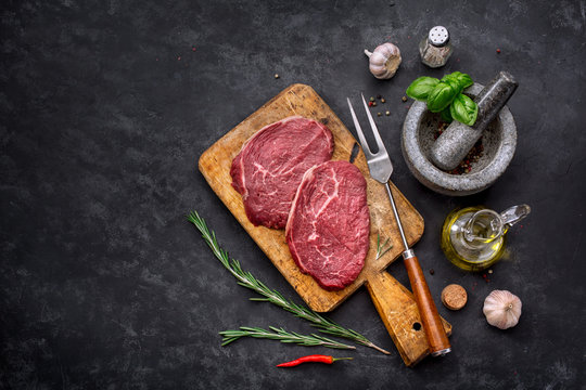 Raw steak with spices and ingredients